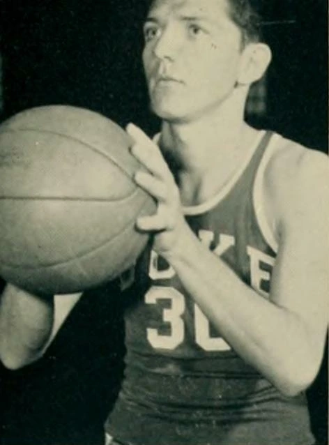 Black-and-white portrait photo of Joe Belmont holding a basketball, from a vintage Duke yearbook-style image.